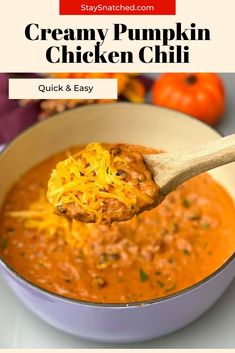 creamy pumpkin chicken chili in a white bowl with a wooden spoon full of the soup