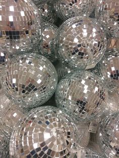 many shiny disco balls are stacked together