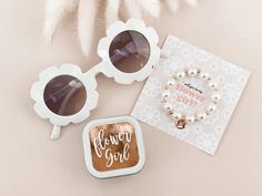 two pairs of sunglasses and a card with the words bow to girl written on them