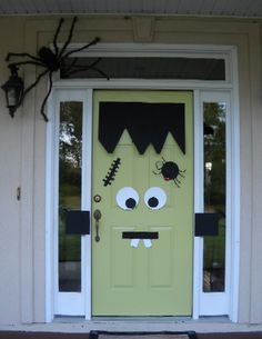 a green door decorated to look like a monster