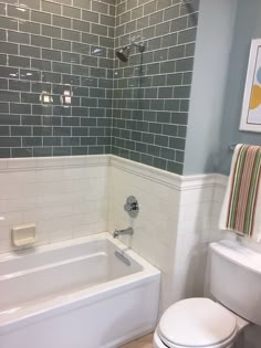 a white toilet sitting next to a bath tub