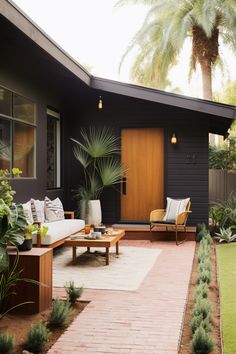 a patio area with couches, tables and potted plants