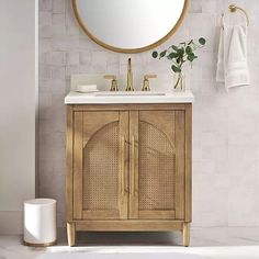 a bathroom with a sink, mirror and towel rack