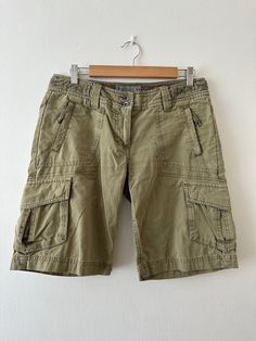 Vintage Y2K 'Fat Face' khaki green ripstop poplin cargo board shorts. Low waist.  UK 10/ small 12. Condition: In good condition. Some marks on front and back. Please see images.  Fabric: 100% cotton. Size: Size stated on garment 10. Fits a UK 10/ small 12. Please check measurements below for fit. Low waist: 32 inches. Hip: 38 inches. Height: 19 inches. Rise: 8.5 inches. Please note: All items are pre worn. Perfect or near perfect condition but some signs of wear may be apparent. Any major floors Cheap Green Cargo Shorts, Utility Khaki Cargo Shorts, Utility Cargo Style Knee-length Shorts, Utility Khaki Shorts With Cargo Pockets, Utility Cargo Knee-length Shorts, Military Khaki Shorts With Pockets, Khaki Knee-length Shorts With Side Pockets, Summer Knee-length Cargo Pants With Built-in Shorts, Green Military Style Cargo Shorts For Outdoor