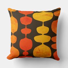 an orange and black pillow with circles on it