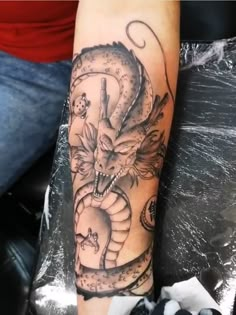 a man with a dragon tattoo on his arm