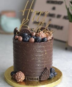 a chocolate birthday cake with blueberries and oreo cookies