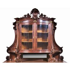 an ornate wooden bookcase with glass doors