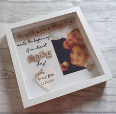 a personalized photo in a white box with a keychain attached to it