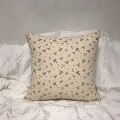 a white pillow sitting on top of a bed