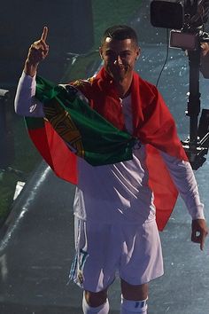 a man holding a flag and giving the peace sign