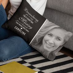 a woman is sitting on the couch holding a pillow with her photo printed onto it