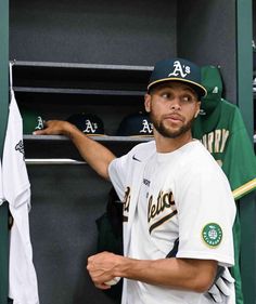 a baseball player is standing in the dugout