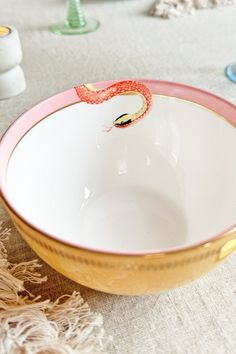 a white and pink bowl sitting on top of a table