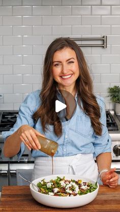 a woman is pouring dressing into a bowl