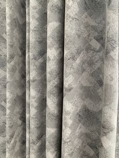 the curtain is made up with grey and white patterns