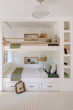 there is a bunk bed in the room with two drawers on each side and shelves above it