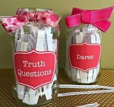 two jars with clothes pins in them and a pink bow on the top one is labeled truth questions