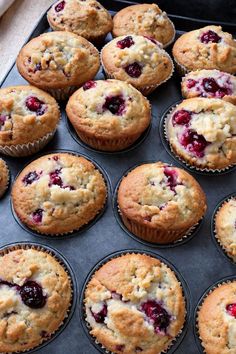 freshly baked muffins with fresh berries in the middle, ready to be eaten