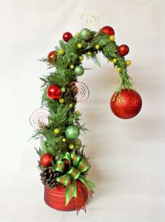 a christmas decoration made out of tinsel and pine cones on top of a potted plant