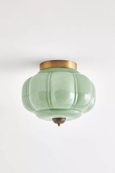 a green light fixture hanging from the ceiling