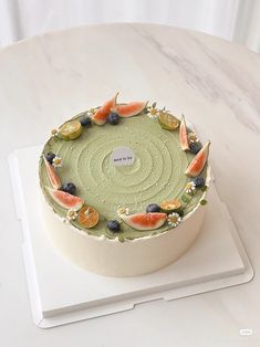 there is a cake with fruit on it