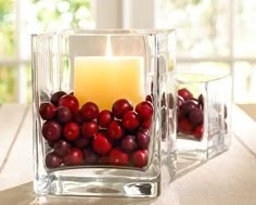 two vases with flowers, candles and fruit are shown in the same photo as each other