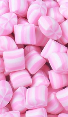 pink and white candy cubes are piled together