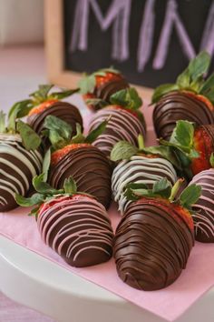 chocolate covered strawberries in a red box with green leaves on the top and bottom