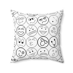 a black and white pillow with many different emoticions on it, including eyes