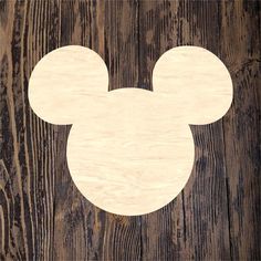 a mickey mouse cut out on wood with the shape of a head in it's center