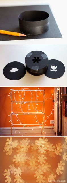 three black round objects with white lights on them and an orange wall in the background