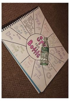 a spiral notebook with writing on it and a bottle in the middle that says baby's birth