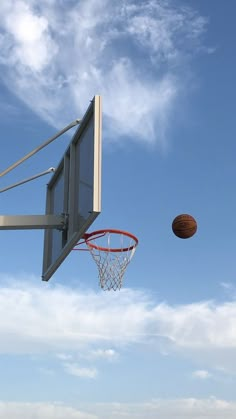 a basketball is in the air near a basket