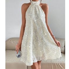 Cream Sequin Halter Mini Dress Xs S M L Xl, 100% Polyester, Ships In 7-8 Days Spring Holiday A-line Dress, White Halter Neck Dress For Party Season, Spring Party Halter Dress, Flowy Fit, Flowy A-line Mini Dress For Party, Flowy Halter Dress For Spring Party, Flowy A-line Sleeveless Party Dress, Glamorous White Sleeveless Summer Dress, Flowy Halter Neck Sleeveless Dress For Party, Spring A-line Sequin Midi Dress