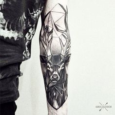 a man with a tattoo on his arm is wearing a deer head and geometric shapes