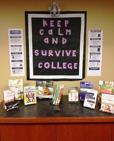 a desk with books and posters on it in front of a bulletin board that says keep calm and survive college