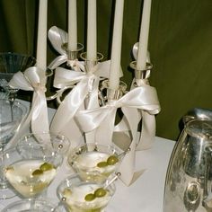 a table topped with wine glasses and candles