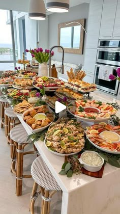 a buffet table filled with lots of different types of food on it's sides