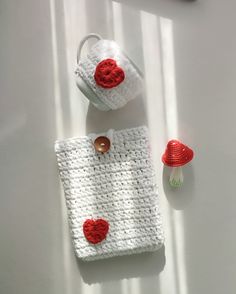 a crocheted bag and cup sitting on a table