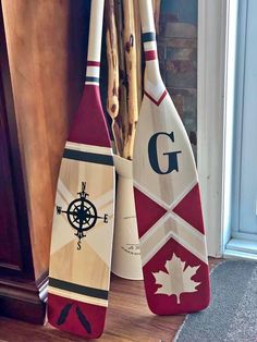 three paddles are sitting next to each other on the floor in front of a door