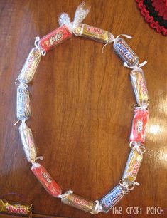 a bracelet made out of candy bars on top of a wooden table