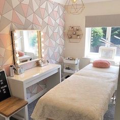 a bedroom with a bed, desk and mirror