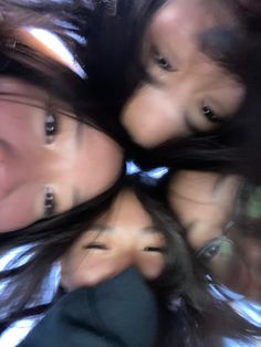 three girls are looking up at the camera