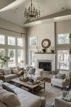 a living room filled with lots of furniture and a clock on the wall above the fireplace