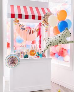 a birthday party with balloons, streamers and a dalmatian dog statue in the window