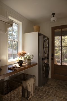 a kitchen with a sink, refrigerator and window next to a basket on the counter