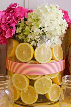 lemons, hydrangeas and other flowers are arranged in a vase