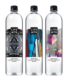 three bottles of water with different designs on the front and back sides, one is empty