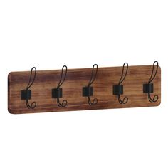 a wooden coat rack with four hooks and two clips on each hook, hanging from the wall